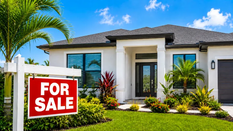 Southwest Florida Home for Sale Modern Southwest Florida home with a for sale sign and tropical landscaping